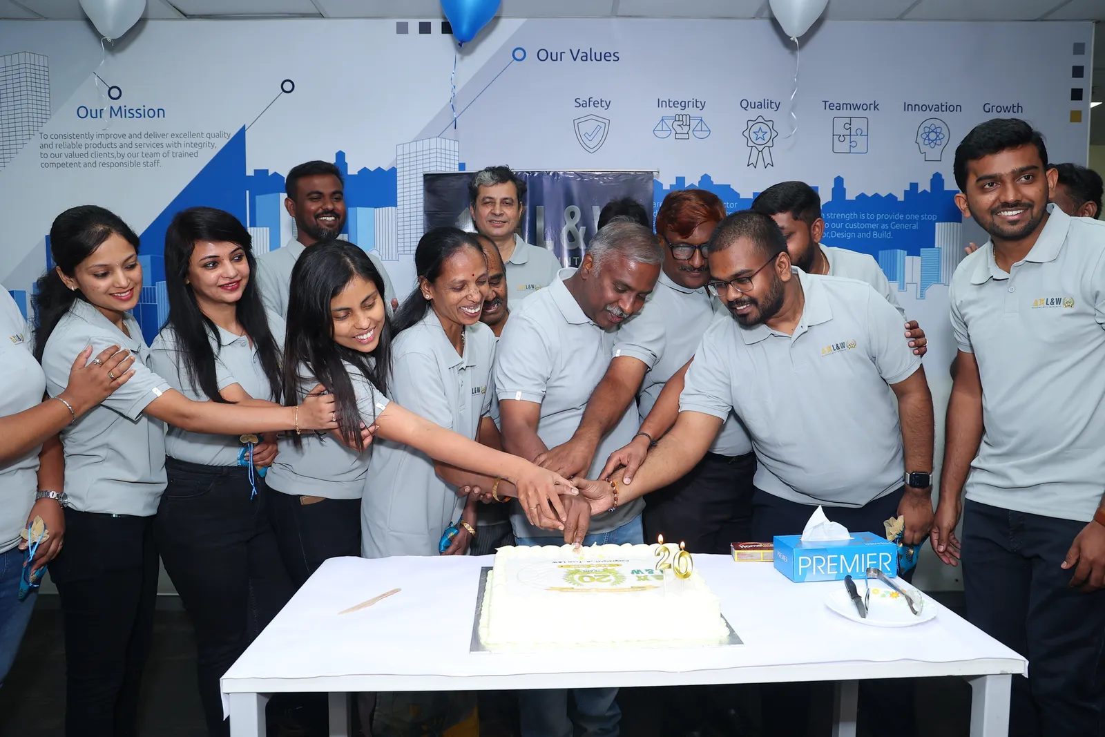Cutting the 20 years cake at the L&W office celebration